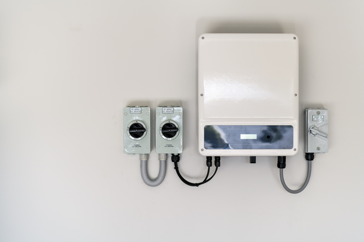 New solar panel inverter with isolators attached to the wall