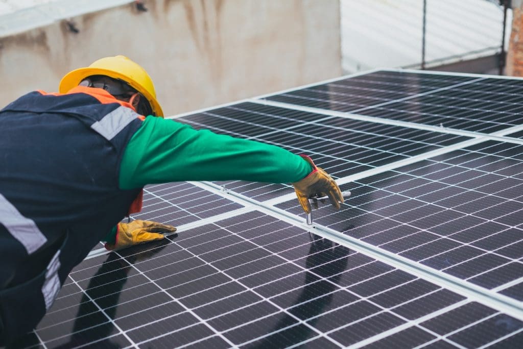 Man working on solar panel